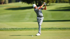 Professional golfer executing proper golf swing with excellent form and balance on fairway, mid-swing follow-through, natural daylight, manicured grass course background